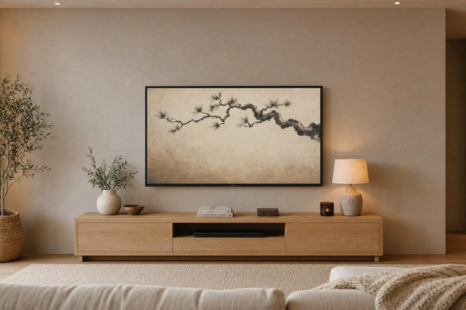 Pine branch artwork displayed on a Frame TV in a warm neutral living room
